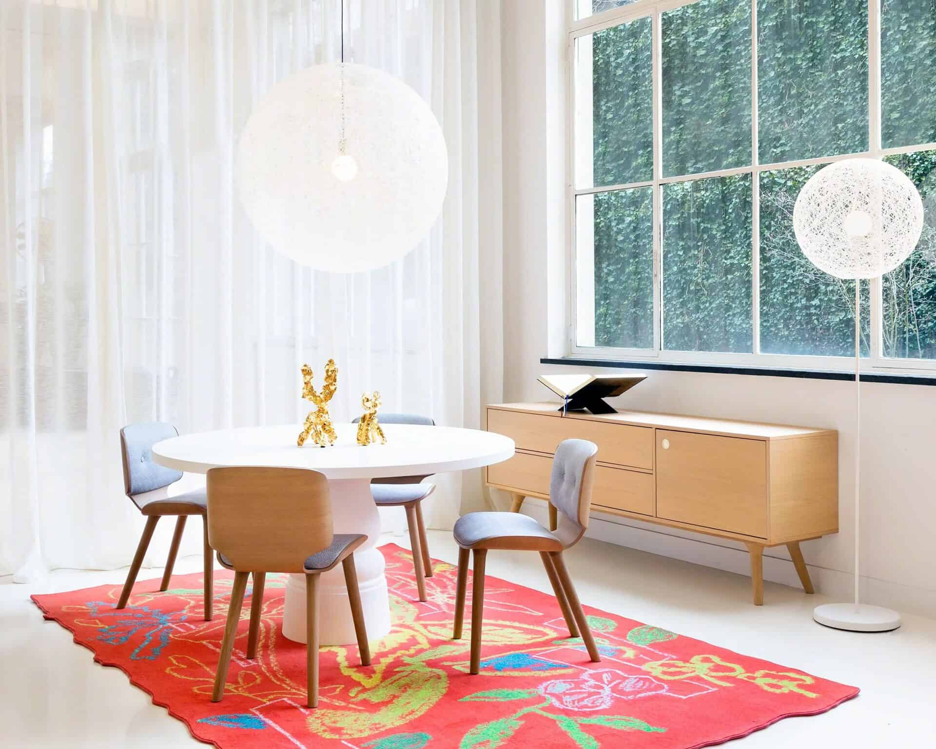 Bright office space with contemporary decor, natural lighting, and a colorful rug for a welcoming business environment.