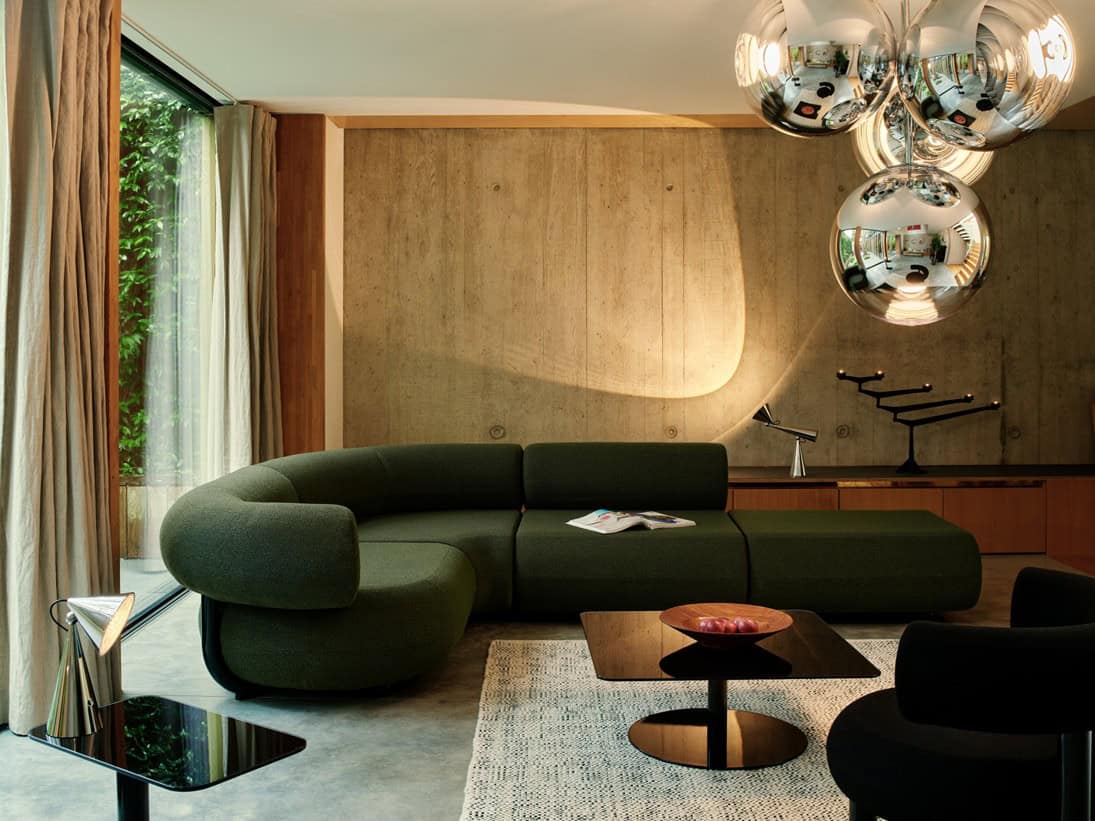 Luxurious office interior with modern sofa, unique lighting, and elegant design elements.